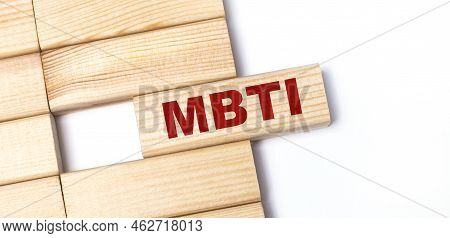 On A Light Background, Wooden Blocks With The Text Mbti. Close-up Top View.