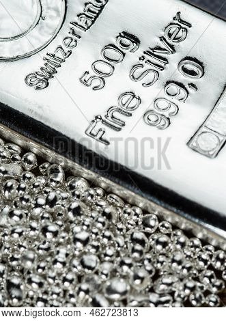 A Silver Bar Weighing 500 Grams  And A Pile Of Silver Grains. Selective Focus.