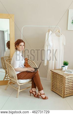 A Business Woman With A Laptop. A Human Design Specialist Works At Home On A Laptop. Work From Home 