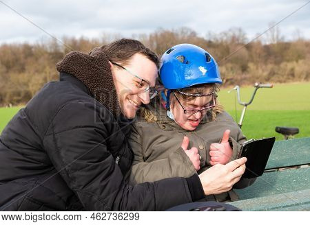 Girl With Blue Cycling  Helmet  Communicating With Her Brother On A Video Call, Hakendover, Belgium