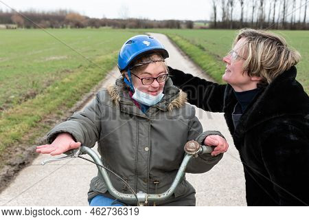 White Girl On A Bike Getting A Hug From Her Thirty Year Old Sister, Hakendover, Belgium
