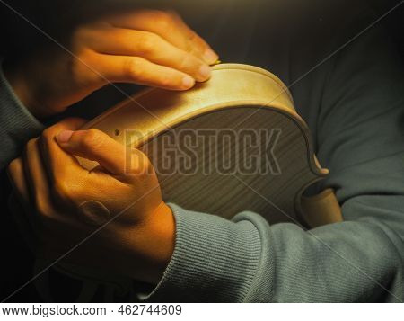 Woman Violinmaker At Work With The Fiddle