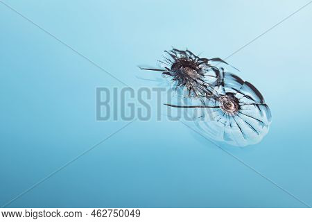 Close Up Of Windshield Damage On Blue, Copy Space. Crack On Car Glass With Traces Of Oncoming Stone 