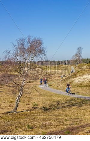 Drente, Netherlands - March 30, 2021: People Walking And Cycling Through The Nature Reserve Drents-f