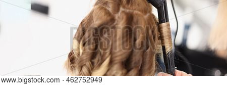 Close-up Of Blonde Woman On Hairdresser Appointment, Master Use Curling Iron Tool For Waving Hair. B
