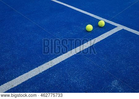 Balls On A Blue Paddle Tennis Court
