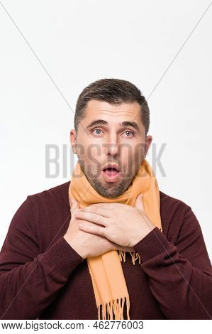 A Man Suffers From A Sore Throat, A Man Wrapped His Throat With A Scarf, Portrait On A White Backgro