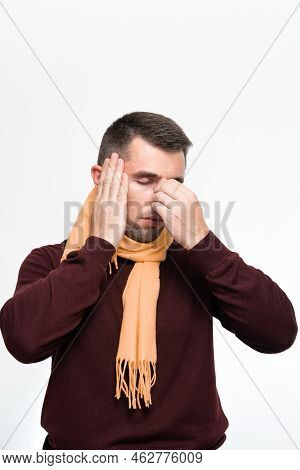 A Man Holds His Hand On His Head Because Of A Headache, Portrait Of A Man On A White Background.