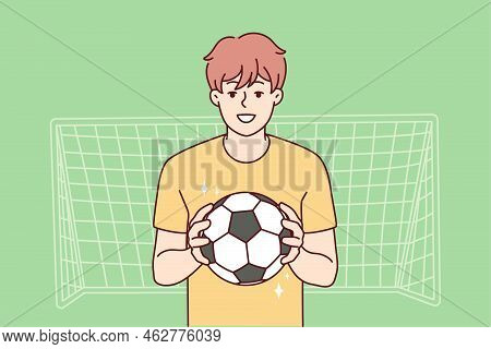 Smiling Guy With Ball Stand Near Gates Playing Football. Happy Male Athlete Or Sportsman Enjoy Socce