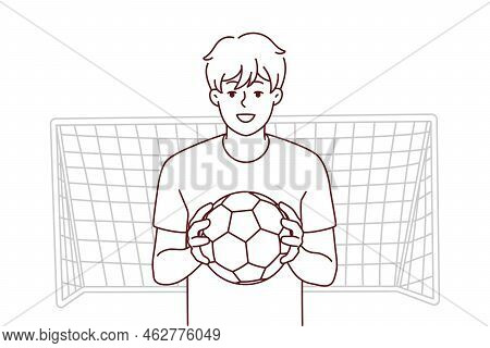 Smiling Guy With Ball Stand Near Gates Playing Football. Happy Male Athlete Or Sportsman Enjoy Socce