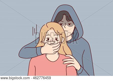 Man In Hood Close Scared Woman Mouth With Hand. Male Criminal Or Offender Attack Terrified Female. C