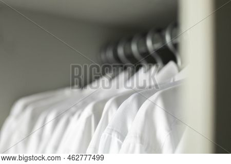 Many White Collar Clean Male Shirts Hangers Cupboard Business Clothes Storage Organization Closeup