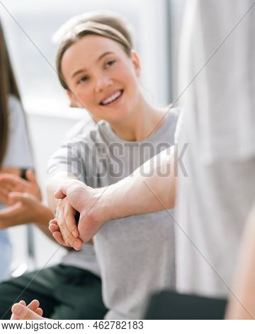 Young Employees Greeting Each Other With A Handshake