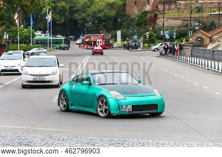 Tbilisi, Georgia - October 10, 2021: Green Sports Car Nissan 350z In A City Street.