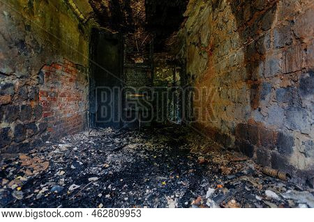 Burnt Building Interior. Ruined Walls In Black Soot. Consequences Of Fire