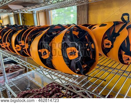 Row Of Helmets Ready For Use At A High Ropes And Climbing Course.