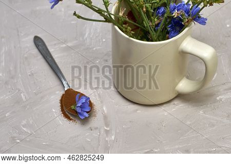 A Spoon With Chicory Flower And Chicory Powder And Chicory Flowers In A Coffee Mug