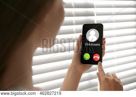 Woman Declining Incoming Call From Unknown Caller Indoors, Closeup. Be Careful - Fraud