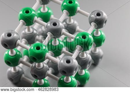 Plastic Model Of A Molecule, Crystal Lattice Of An Atom On A Gray Background, Close-up. Organic Chem