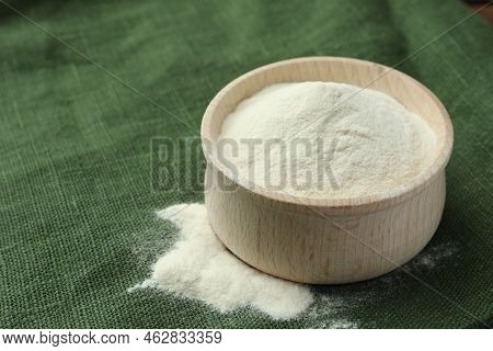 Wooden Bowl Of Agar-agar Powder On Green Tablecloth, Closeup. Space For Text