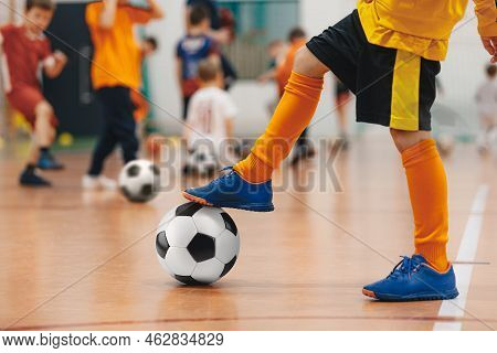 Football Futsal Training For Children. Soccer Training Drill. Indoor Soccer Young Player With A Socc