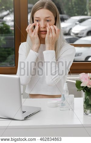 Self Face Massage On-line Course Near Laptop. Woman Doing Anti-age Massage Near Computer. Young Fema
