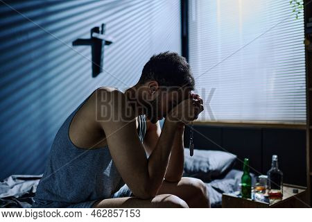 Side View Of Young Inconsolable Man With Post Traumatic Syndrome