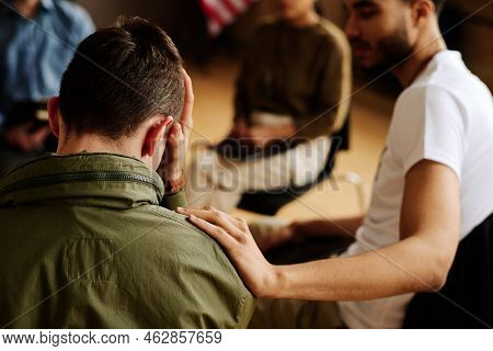 Rear View Of Young Unhappy Man Suffering From Loss Or Traumatic Experience
