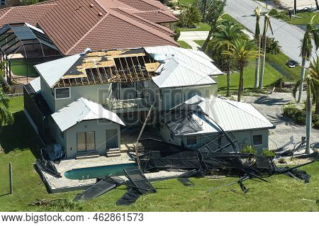 Hurricane Ian Destroyed House In Florida Residential Area. Natural Disaster And Its Consequences