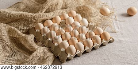 Fresh Organic Chicken Eggs In Carton Pack Or Egg Paper Container On A Sacking. Zero Waste Packaging 
