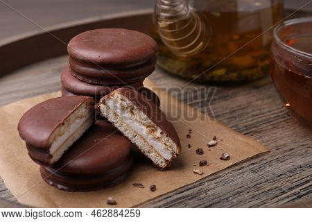 Tasty Choco Pies And Tea On Wooden Tray, Closeup View