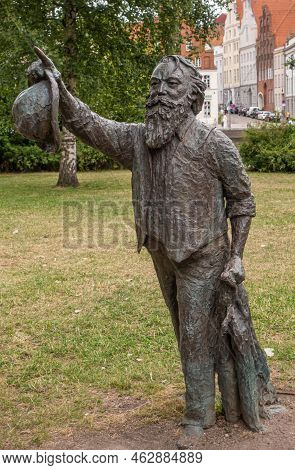 Germany, Lubeck - July 13, 2022: Closeup Of Johannes Brahms Black-green Bronze Statue Set In Green G