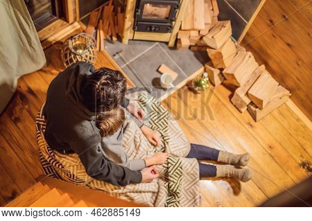 Dad And Son Spend Time By The Fireplace In Glamping. Rest In The Mountains In Glamping. Cozy Firepla