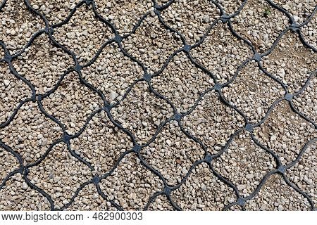 Geogrid Used At The Base Of A New Pedestrian Road, Road Construction, Reinforcement Covered With Fin