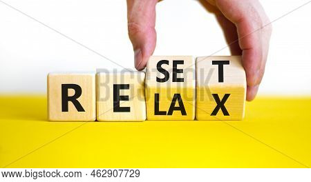 Relax And Reset Symbol. Businessman Turns Cubes And Changes The Word 'relax' To 'reset'. Beautiful Y