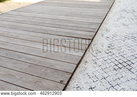 Wooden Walkway, Pedestrian Path Made Of Fine Gravel Reinforced With Geogrid In A Public Park. Archit