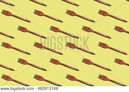 Top View On Many Bamboo Forks On A Yellow Background, Eco Tableware, Disposable Cutlery, Wood Biodeg
