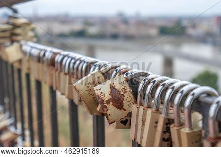A Padlock Attached To A Bridge Railing In A Spring Park. Lovelock.