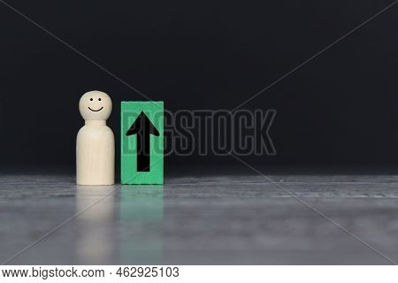 Wooden Doll And Upward Arrow With Copy Space. Upskill Employee, Promoted And Performance Concept