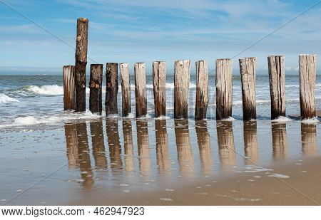 Sand, A Wooden Pier And Reflections At The Cadzand Beach, The Netherlands