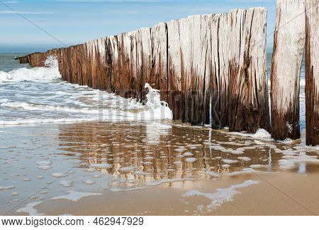 Sand, A Wooden Pier And Reflections At The Cadzand Beach, The Netherlands