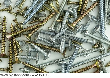 Metal Bolts And Nuts In A Row Background. Chromed Screw Bolts And Nuts Isolated. Steel Bolts And Nut