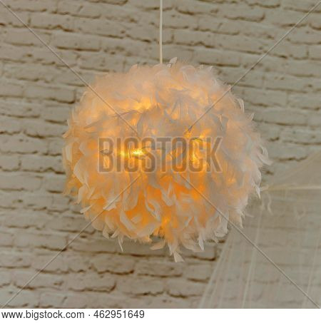 Modern Lamp With Abajur Made Of White Feathers, Gives Romantic Light In Bedroom