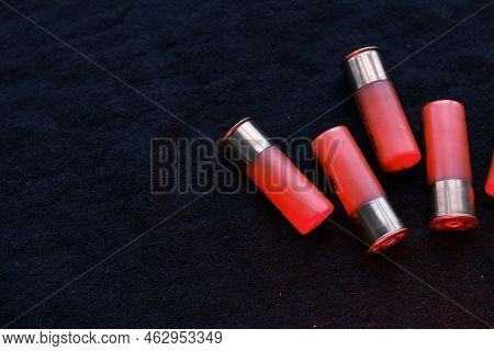 Shotgun Shells On A Black Surface. Ammunition For 12 Gauge Smoothbore Weapons. Hunting Ammunition. D