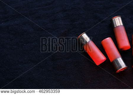 Shotgun Shells On A Black Surface. Ammunition For 12 Gauge Smoothbore Weapons. Hunting Ammunition. D