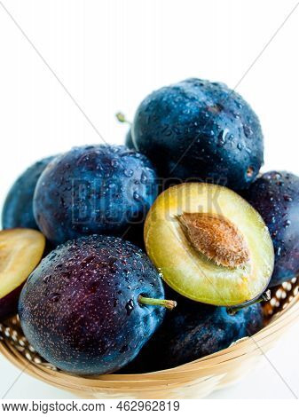 Fresh Plums In Basket On White Background.