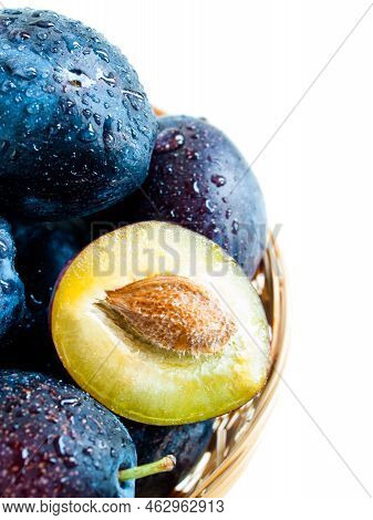 Fresh Plums In Basket On White Background.