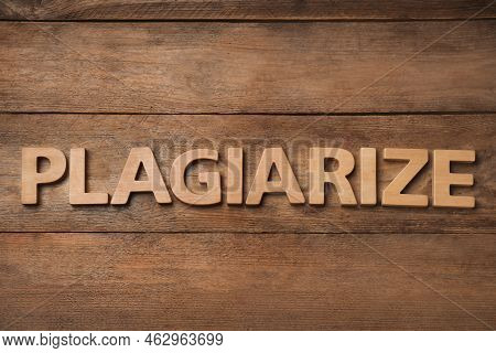 Word Plagiarize Made Of Wooden Letters On Table, Flat Lay