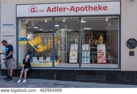 Germany, Lubeck - July 13, 2022: Closeup Of  Adler Pharmacy Window, Display Drugs And Banners, On  F