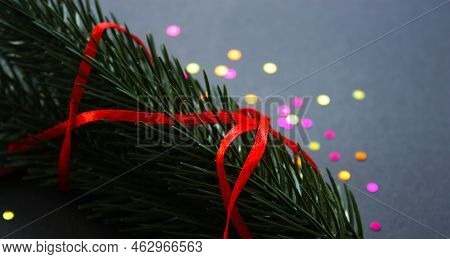 Vibrant Christmas, New Year 2023 Deecorations. Twigs Of Green Spruce Tree With Thin Red Ribbon. Circ